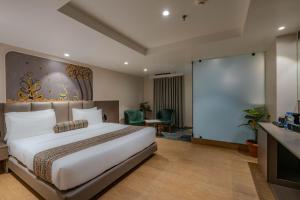 a hotel room with a bed and a projection screen at Hotel Shivashish in Ahmedabad