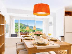 a dining room with a table with plates and glasses at Luxury Duplex - 2 Terraces - Private Beach in Tossa de Mar