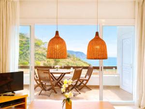 a dining room with a table and a view of the ocean at Luxury Duplex - 2 Terraces - Private Beach in Tossa de Mar