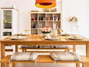 a dining room table with plates and glasses of wine at Luxury Duplex - 2 Terraces - Private Beach in Tossa de Mar