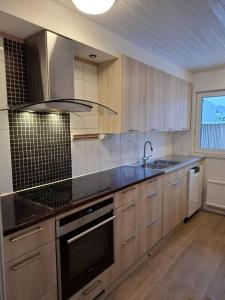 a kitchen with a sink and a stove top oven at Workers Stay - Construction Worker Housing in Gothenburg