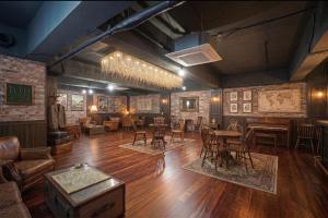 a room with tables and chairs and a piano at Midpoint Guesthouse in Busan