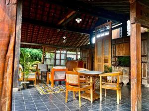a patio with a table and chairs on a porch at PaddyView Hostel in Banyuwangi