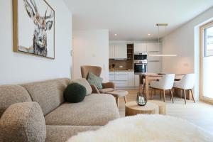 a living room with a couch and a table at Alpenlodge LEO in Mittenwald