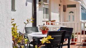 a patio with a table and chairs on a balcony at Villa Tex in Neum +71 photos