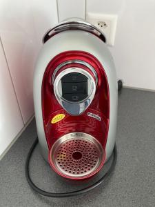 a red and white toaster sitting on the floor at Zentrale Unterkunft in Bern