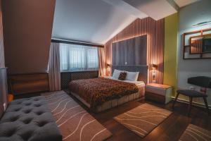a bedroom with a bed and a large window at Hotel Sumski Feneri in Trnovo +52 photos