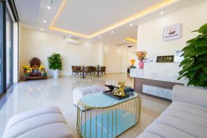 a lobby with a waiting room with chairs and a table at The Sea Light Hotel Phú Quốc- Sunset and Ocean View in Phú Quốc