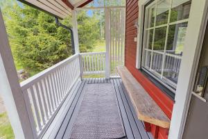 a front porch of a home with a white railing at Villa Lepola Sauna Suite in Rovaniemi