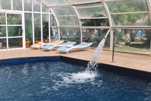 a pool with a fountain in front of a building at Hotel Bonalba Alicante in El Campello +34 photos