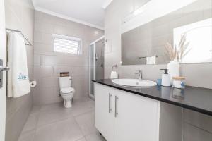 a white bathroom with a sink and a toilet at Uitzicht in Springbok +24 photos