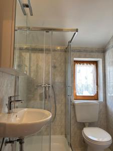 a bathroom with a sink and a toilet and a shower at Apartman Karla in Selce