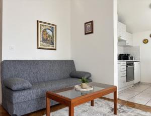 a living room with a couch and a coffee table at Apartman Karla in Selce