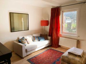a living room with a white couch and a window at Landhaus Wahmbeck in Wahmbeck