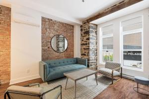 a living room with a couch and a table at Meramont Hotel Downtown in Montreal