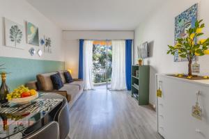 a living room with a couch and a table at Super Menton Bord Mer in Menton