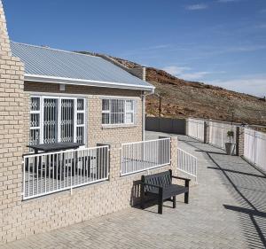 a brick building with a bench in front of it at Uitzicht in Springbok