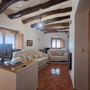 a living room with a couch and a table at La Casilla de la Fuente in Trevélez