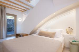 a bedroom with a white bed in a room at Miles Away Residences in Platis Gialos +143 photos