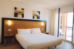 a bedroom with a large bed and a balcony at Hotel Bonalba Alicante in El Campello