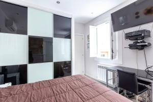 a bedroom with a bed and a desk and a chair at Malasaña & Plaza España in Madrid