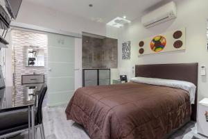 a bedroom with a large bed and a television at Malasaña & Plaza España in Madrid
