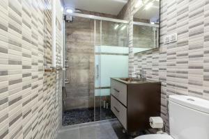 a bathroom with a shower and a toilet and a sink at Malasaña & Plaza España in Madrid +39 photos