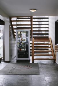 a vending machine in a room with a staircase at Hotel Germania in Puerto Varas