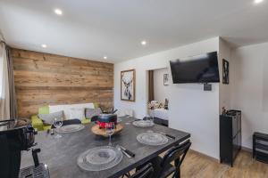 a living room with a table with wine glasses on it at Les Caribous - Lac 1 min, Espace Diamant, Megeve in Praz-sur-Arly