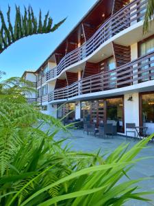 an external view of a building with chairs and tables at Hotel Germania in Puerto Varas