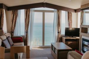 a living room with a view of the ocean at Lower Cliff 19 in Easton