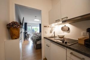 a kitchen with a sink and a counter top at Boutique-Apartment Südblick direkt im Zentrum in Oberstdorf