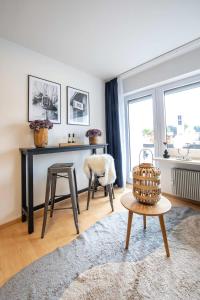 a living room with a table and a stool at Boutique-Apartment Südblick direkt im Zentrum in Oberstdorf