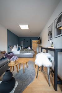 a bedroom with a bed and a living room at Boutique-Apartment Südblick direkt im Zentrum in Oberstdorf
