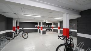two bikes are parked in a parking garage at Hotel Princesa Parc in Arinsal