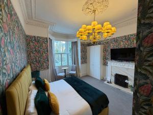 a bedroom with a bed and a chandelier at Grangeview Guest House in Edinburgh