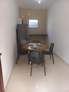 a small table and chairs in a small room at Apartamentos da Lua in Barreirinhas +4 photos
