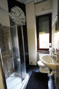 a bathroom with a shower and a toilet and a sink at K-Smart in Catania