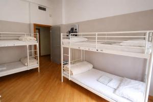 a room with three bunk beds with white shelves at K-Smart in Catania +4 photos