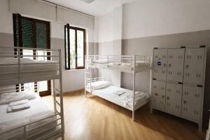 a room with three bunk beds and a window at K-Smart in Catania