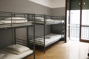 a room with three bunk beds and a window at K-Smart in Catania