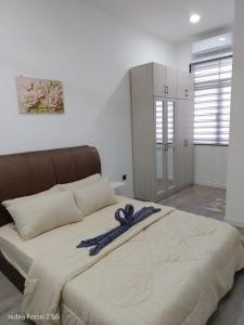a large bed with a ribbon on top of it at HOMESTAY IMPIAN AYER MOLEK MUSLYM only in Malacca