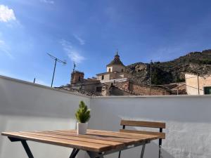 a wooden table sitting on top of a white wall at Casa Rural Las Vueltas in Mula
