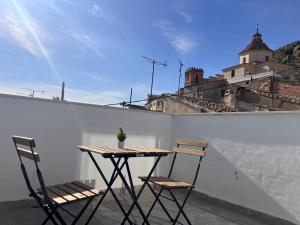 a table and two chairs sitting on a balcony at Casa Rural Las Vueltas in Mula +1 photo