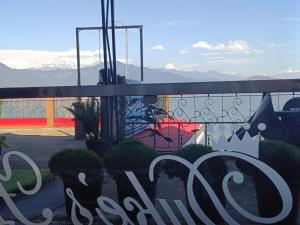 a view of a playground with mountains in the background at Duke's RestHome in Kalimpong +2 photos