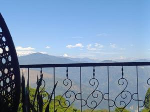 a view of the mountains from a balcony at Duke's RestHome in Kalimpong