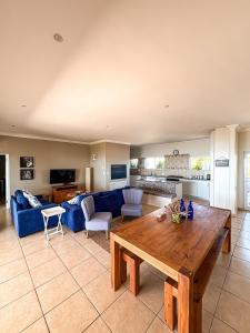 a living room with a blue couch and a table at On The Hill in Stompneusbaai +53 photos
