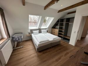 a bedroom with a bed and a television in it at StrandBerg's Onkel Tommys Hütte in Braunlage
