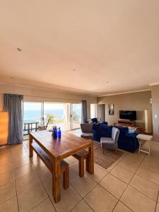 a living room with a table and a couch at On The Hill in Stompneusbaai