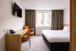 a hotel room with a bed and a desk at Hotel Le Bois De Bruges in Bruges +79 photos